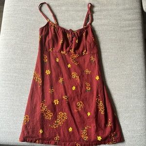 Maroon colored mini dress with yellow and orange flowers